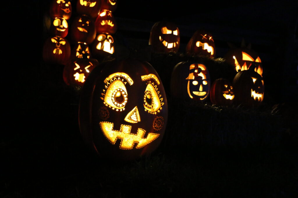 Glowing pumpkins with carved faces.